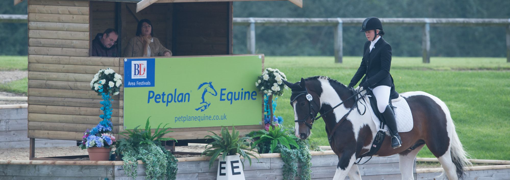 A woman on a horse jumping over an obstacle