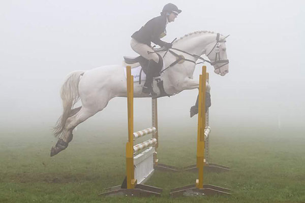 Show jumping in the mist at Treborough Horse Trials photographed by jayphotos