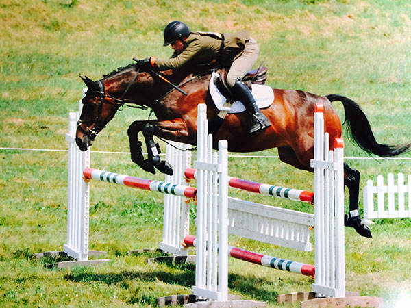 Jack riding Scooby in the show jumping at Chepstow